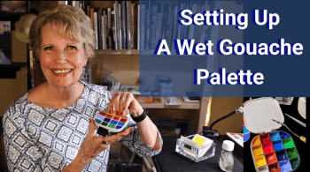 Woman holding a colorful gouache palette for painting setup.